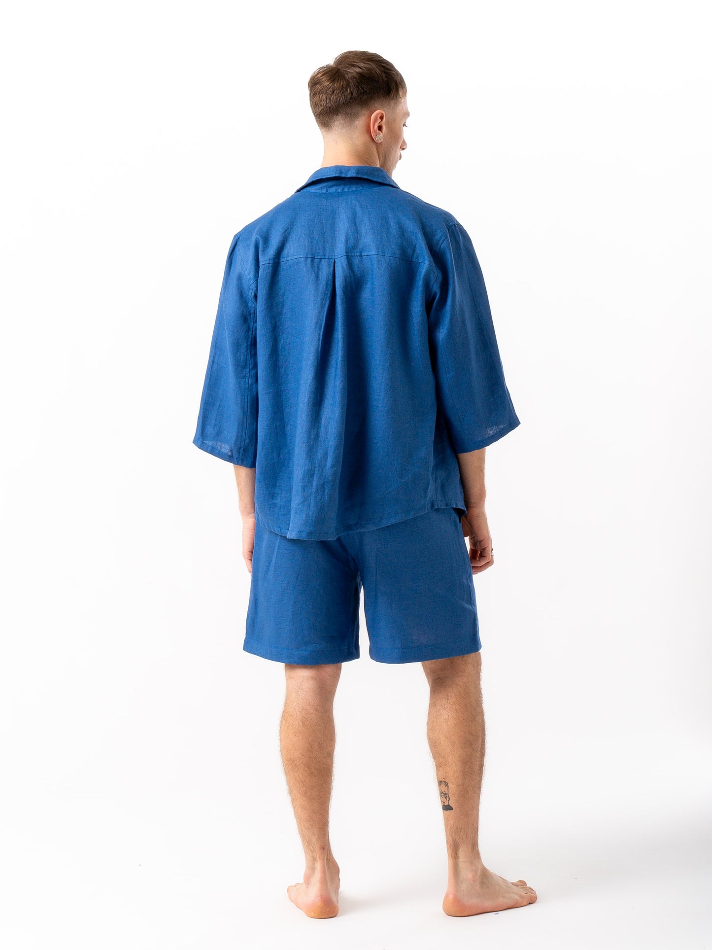 Man wearing high quality linen shorts and shirt in blue