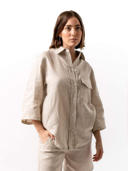 woman wearing button up shirt in beige