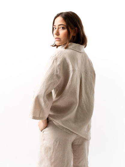 woman wearing button up shirt in beige